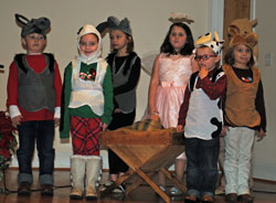 Nativity scene with children dressed as animals, angels, etc.