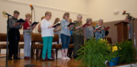 Adult Choir singing at the CLC note burning service