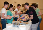people at the food tables