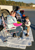 Snowflake angel giving candy to Alfalfa dressed up child at Trunk or Treat