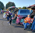 Line of vehicles and Trick or Treaters at Trunk or Treat event 2020